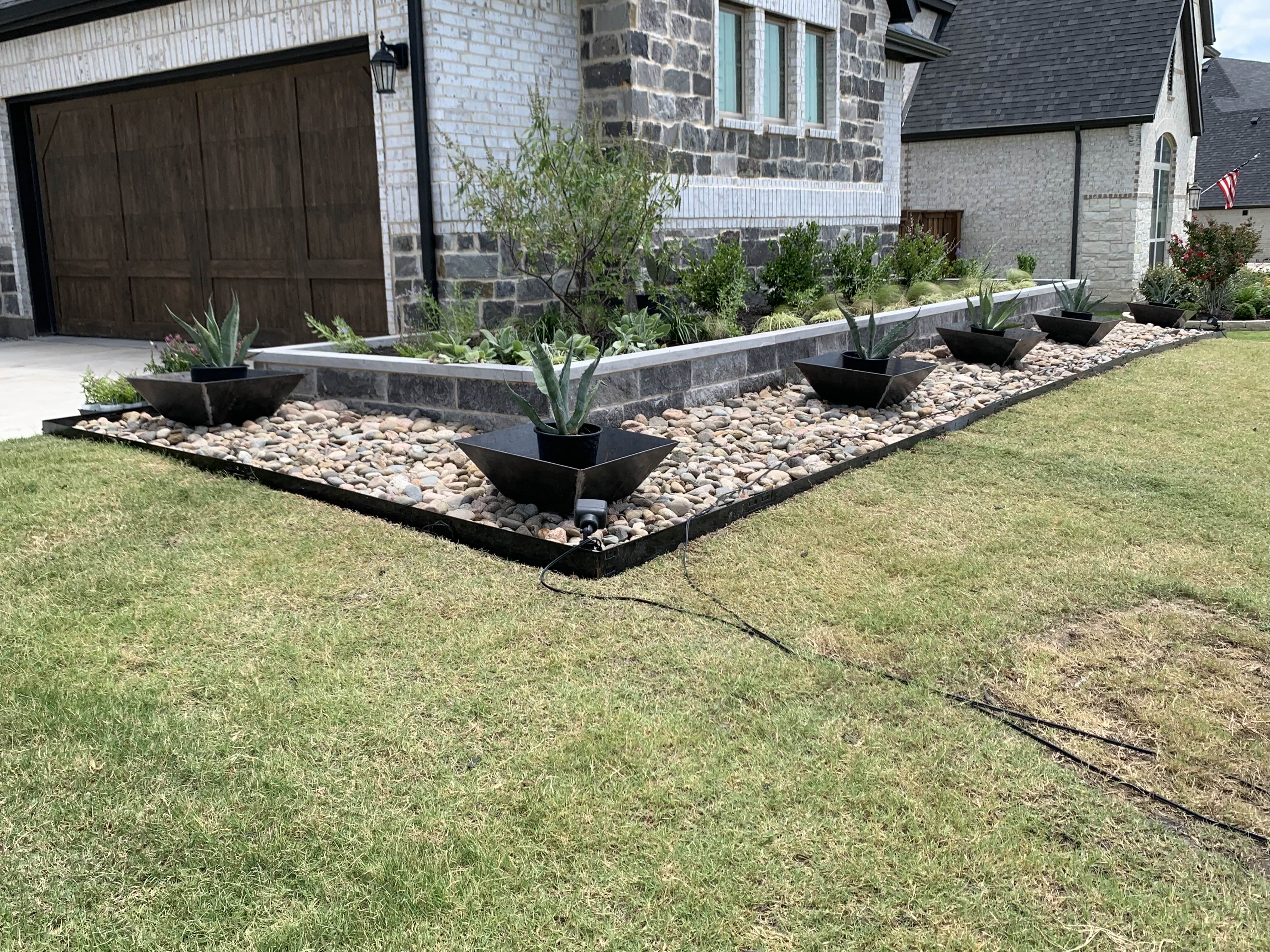 Modern steel planters with agave plants in front yard landscape design